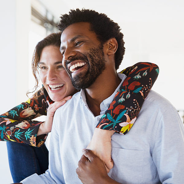Laughing, affectionate multi-ethnic couple
